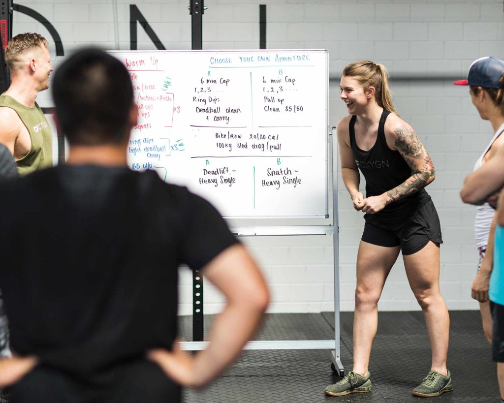 CrossFit_OXYGEN_Coaches_Holly-and-Andrew-at-the-whiteboard