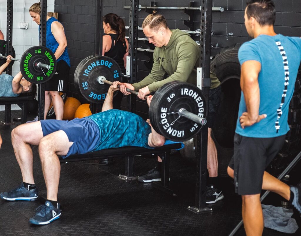 andrew helping spot a bench press lift 