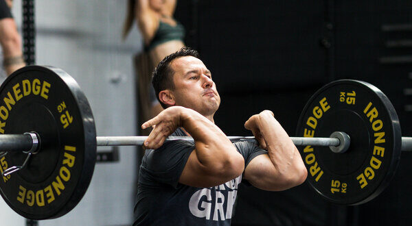 man lifting barbell in a squat